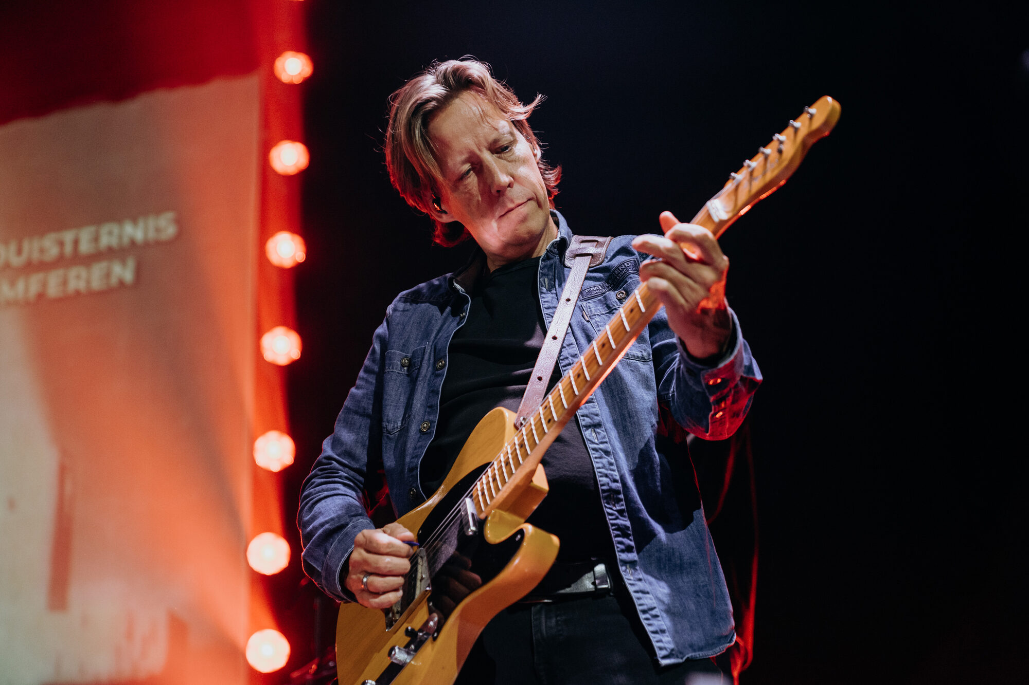 Arend Jansen speelt gitaar tijdens de live-opname van Jezus Messias