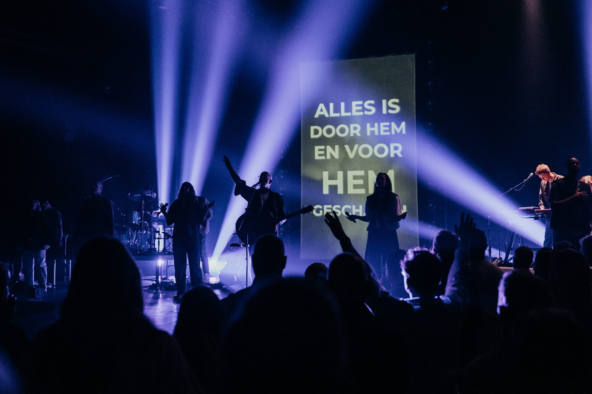 Liedtekst van Jezus Messias op de schermen boven het podium